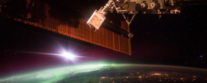 Astronaut Scott Kelly snapped this shot of the aurora borealis while aboard the International Space Station. The largest cluster of lights in view is North Dakota’s Bakken shale formation.jpg